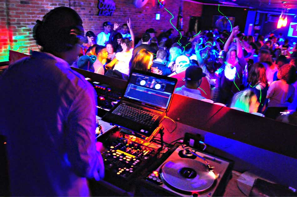 Man playing DJ music at a party